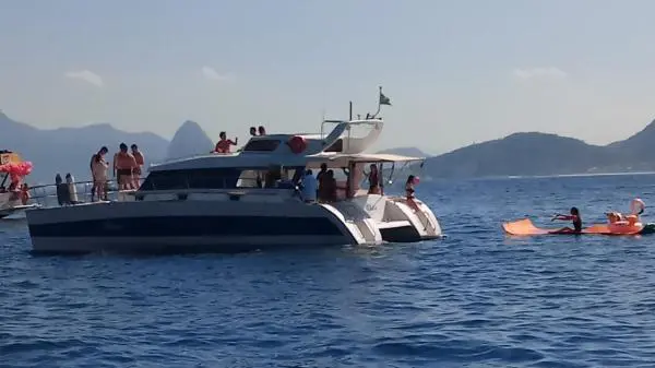 Catamarã Power Cat 40 com grupo de pessoas aproveitando um passeio exclusivo no Rio de Janeiro.