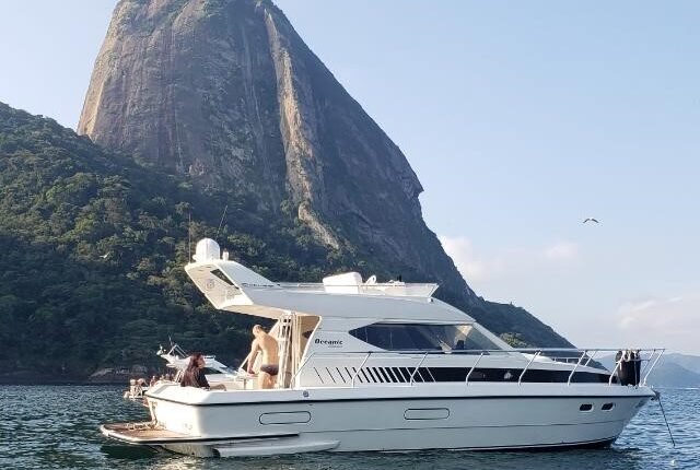 Lancha Oceanic 36 navegando próximo ao Pão de Açúcar, no Rio de Janeiro, durante passeio de barco exclusivo.