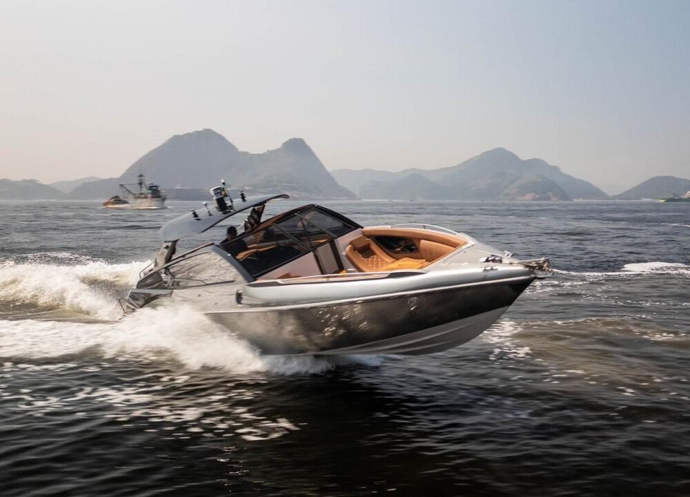 Lancha AZOV Z380s navegando em alta velocidade em águas do Rio de Janeiro com vista das montanhas ao fundo.