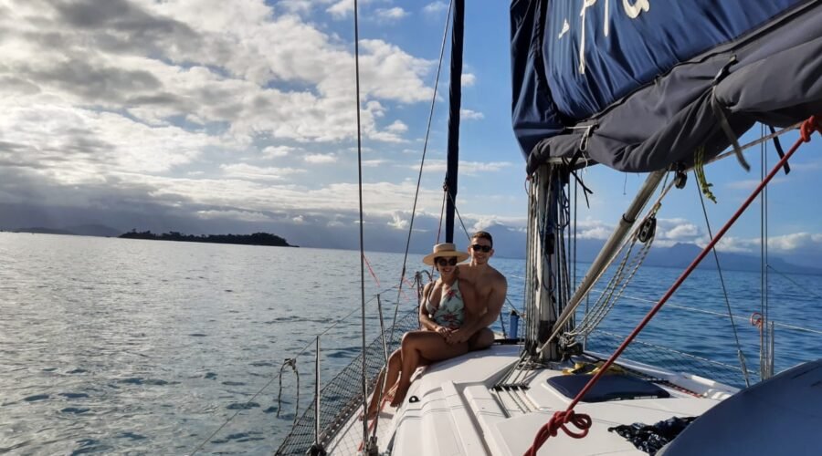 Casal no passeio de barco no convés do veleiro Delta 36' em Paraty